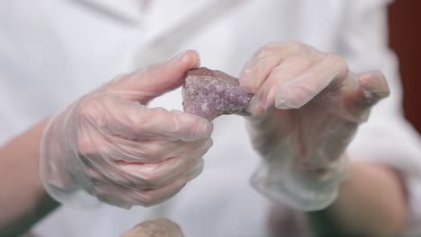 scientist examining amethyst crystal