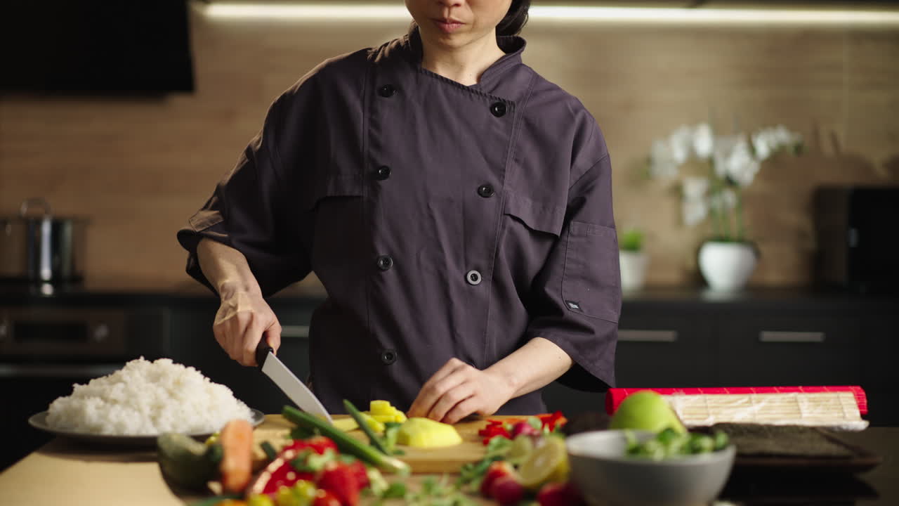 Asian chef preparing sushi in kitchen