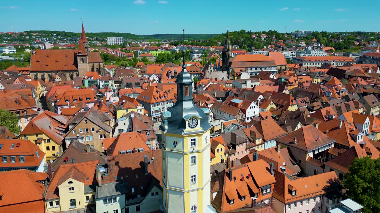 4K Aerial Drone Video of the Historic Herrieder Clock Tower and the St. Johannis Church in the Old Town area of Downtown Ansbach, Germany