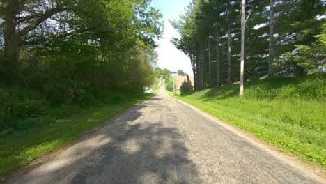 POV-driving-past-farm-yards-and-unused-fields-in-rural-Illinois