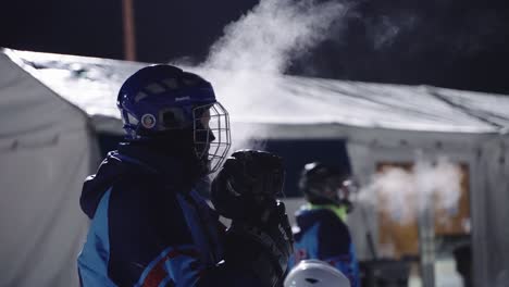 outdoor hockey players breath appears as a misty cloud in the cold air