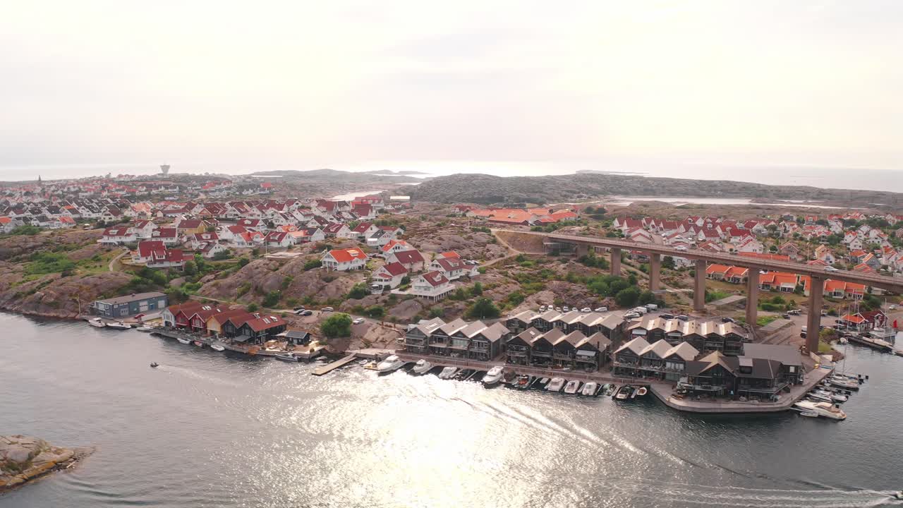 Coastal village in Norway with scenic houses, bridge, and water view under soft light