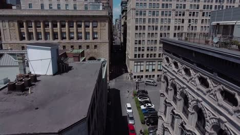 going up through city buildings during a sunny day aerial, montreal