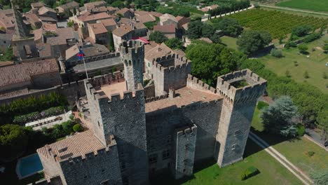 Château-de-Pouzilhac-overseeing-lush-vineyards---Aerial-flyover