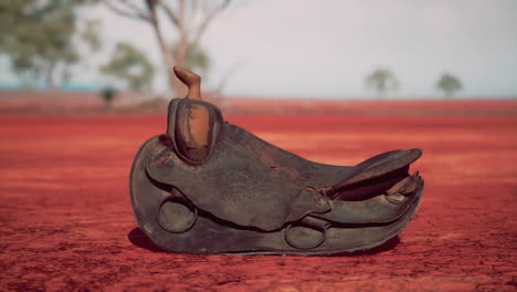 old decorated mexican saddle lying on sand