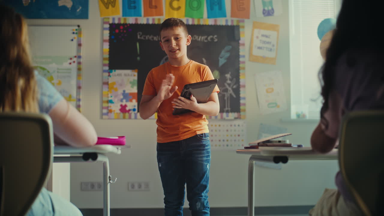 Serious elementary age boy surfing internet on tablet during school break
