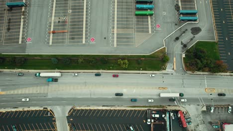 top down tracking aerial of a local green semi tractor and trailer