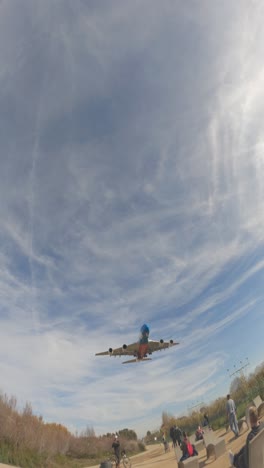 airplane landing over a city park