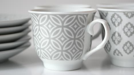 elegant grey and white porcelain coffee cups and saucers