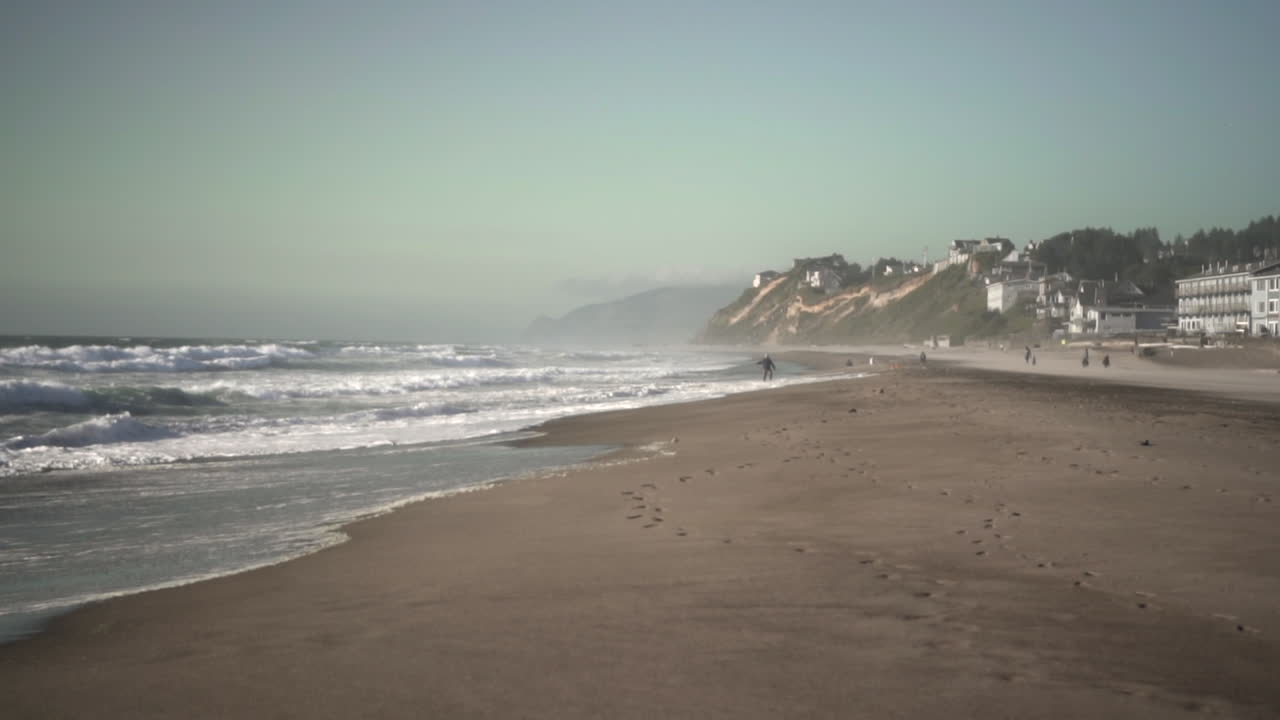 handheld shot with waves crashing on the beach