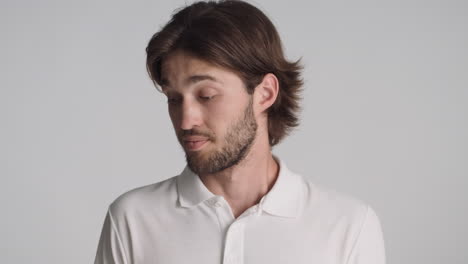 caucasian man in front of camera on gray background.