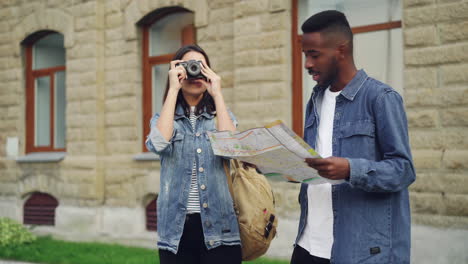 couple exploring the city with map and camera