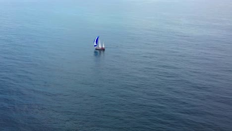 aerial-view-of-sailing-ship-in-the-vast-blue-ocean,-4k