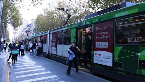 passengers disembark tram at melbourne street stop