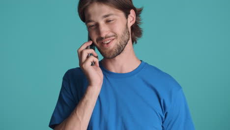 Caucasian-man-in-front-of-camera-on-blue-background.