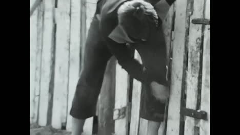 soviet man bending to pick up object, video from soviet union archive. circa ussr 1980s: a man from the soviet union is bending over to pick up something, captured in this archival video.