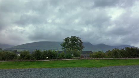 timelapse of dramatic clouds racing over hills in uk's lake district scenery.