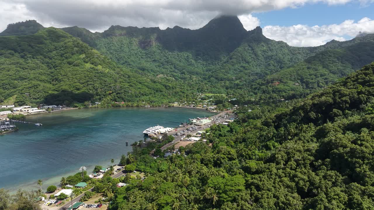 Drone Shot of Moorea Island, French Polynesia. Harbor and Bay Under Green Rainforest and Hills