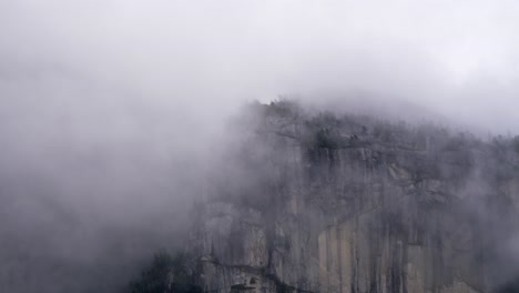 thechief, squamish, british columbia, canada - a view of a mountain summit veiled in fog - close up