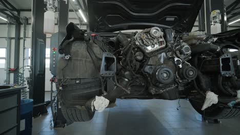 disassembled car engine in repair shop