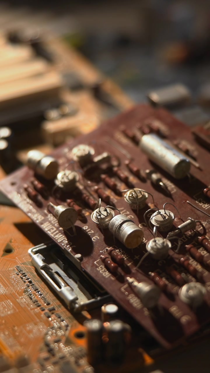 Closeup Circuit Board On Workbench Showing Capacitor Array And Traces Under Warm Lamp Engineer Role Performing