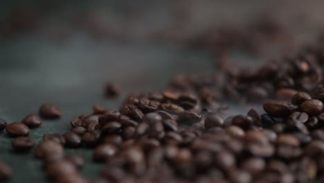 Dolly-right-of-coffee-beans-lying-on-the-dark-green-background