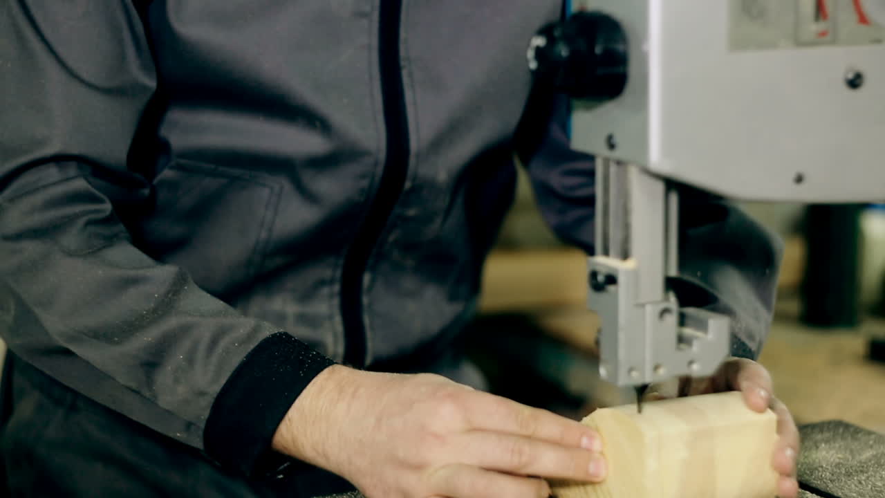 Sawing A Wooden Plank With Jig Saw. Man uses an electric saw to cut wooden planks