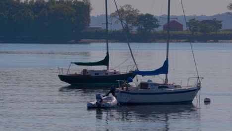 boats on the water at city island in new york, with hart island in the background