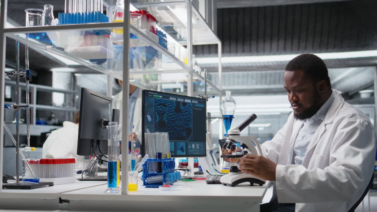 Vertical video Lab scientist using microscope to evaluate cellular structures