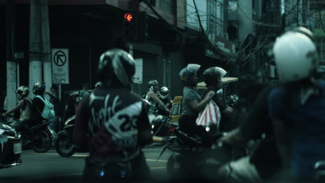 busy city street intersection with motorbikes and traffic
