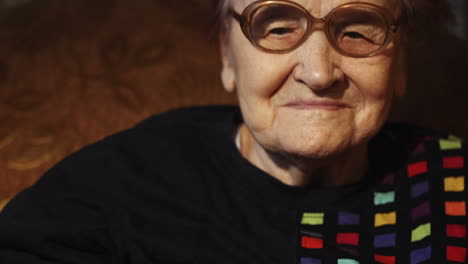 elderly woman putting on glasses