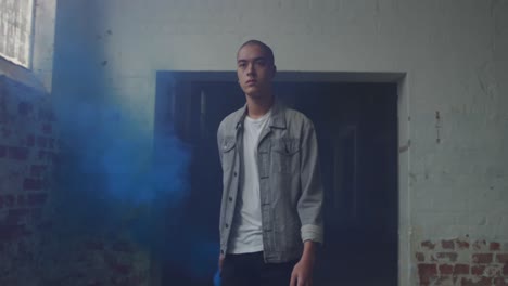 fashionable young man in an abandoned warehouse