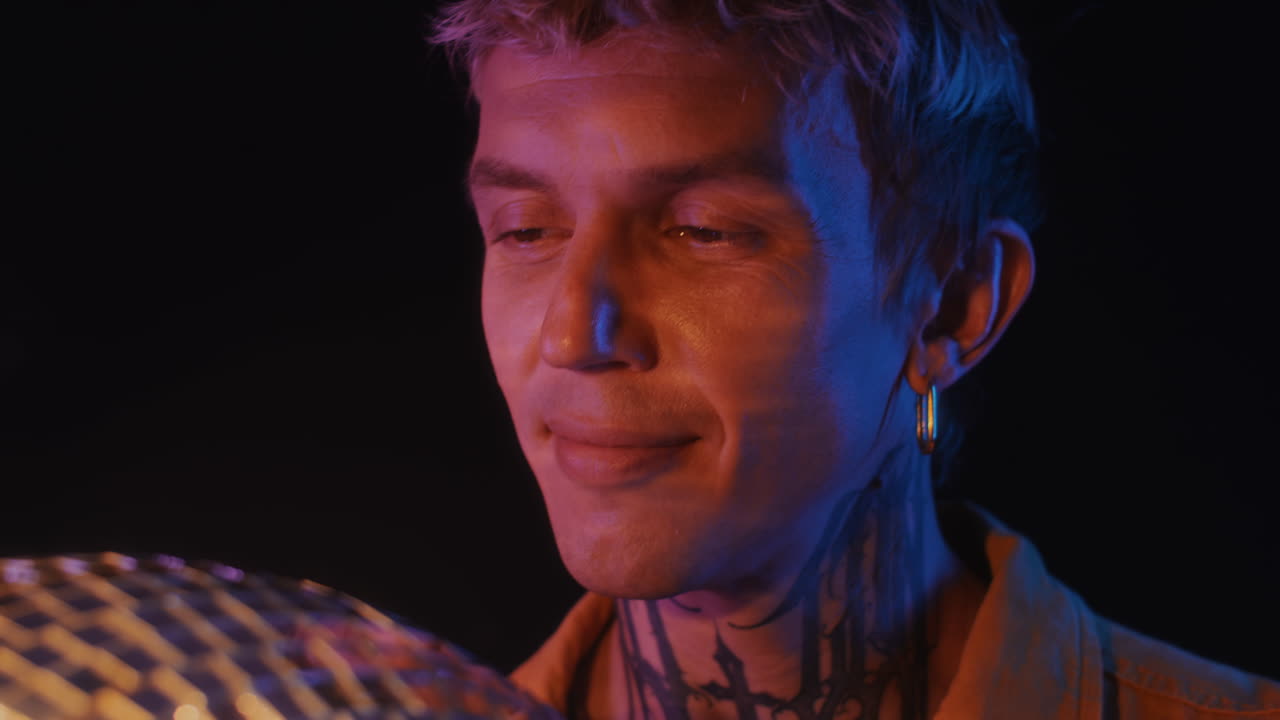 Caucasian Guy Looking at Disco Ball in Nightclub