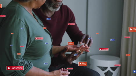 senior couple taking medication indoors, displaying floating subscribe, like, play icons for health