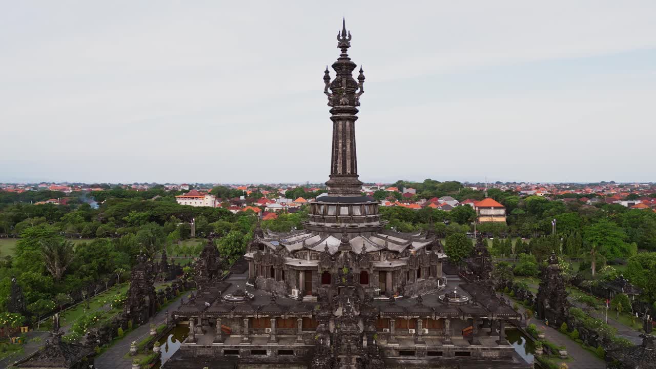 Drone footage captures the Bajra Sandhi Monument in Renon, Bali, with its iconic tower structure, representing the historical journey of the Balinese people, surrounded by lush public gardens