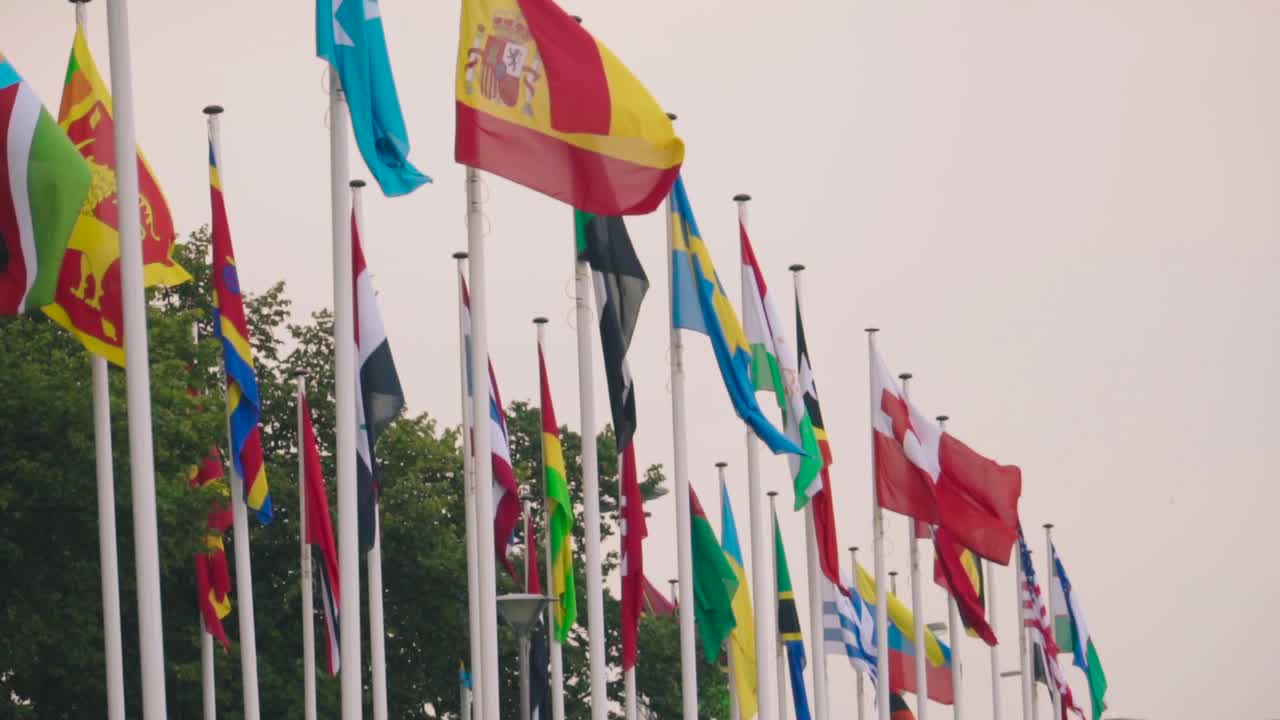 banderas de los países del mundo en astas de bandera ondean en el viento