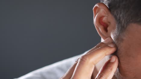 close-up of a person touching their ear