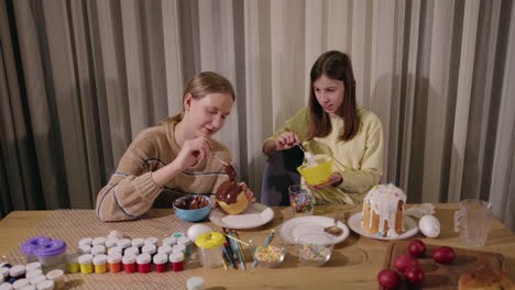 sisters decorating easter eggs and paska