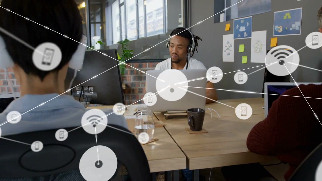 Center man using laptop while node emerging, causing tech overlay mapping devices across desk