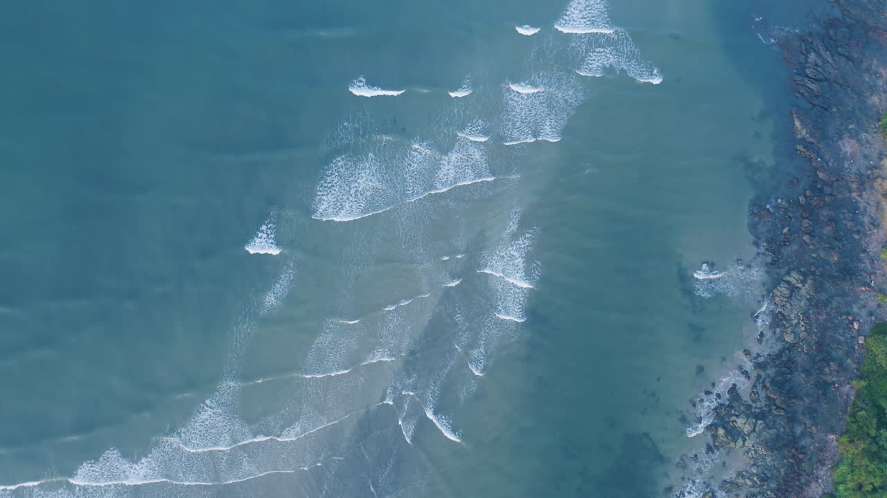 Aerial view of sea waves and clean beach