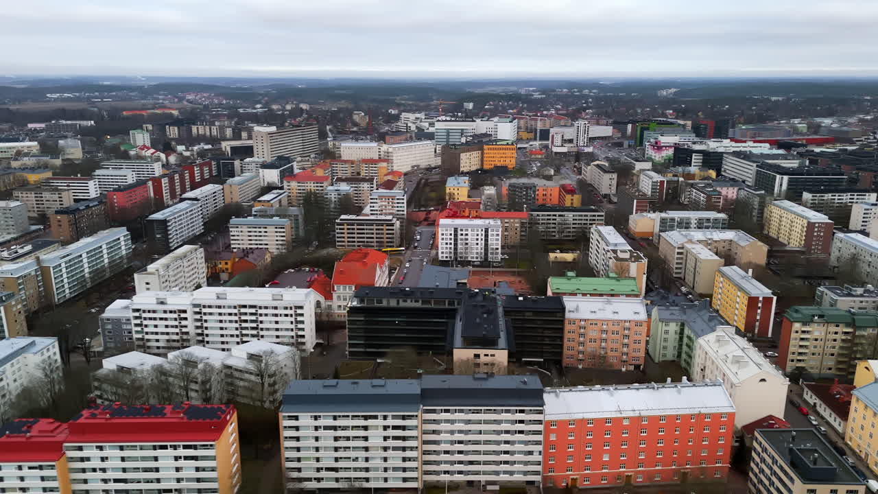 Aerial tracking shot over colorful condos in Turku city, rainy day in Finland