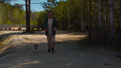 man and dog enjoying a run in the park