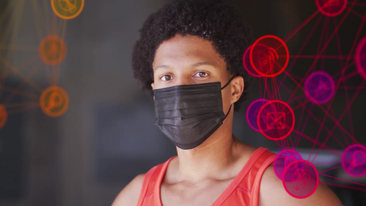 Animation of media icons over african american man with face mask