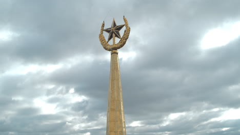 golden star emblem on a cloudy sky