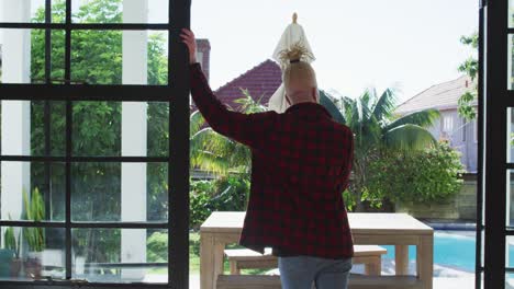 Thoughtful-albino-african-american-man-with-dreadlocks-looking-at-the-window