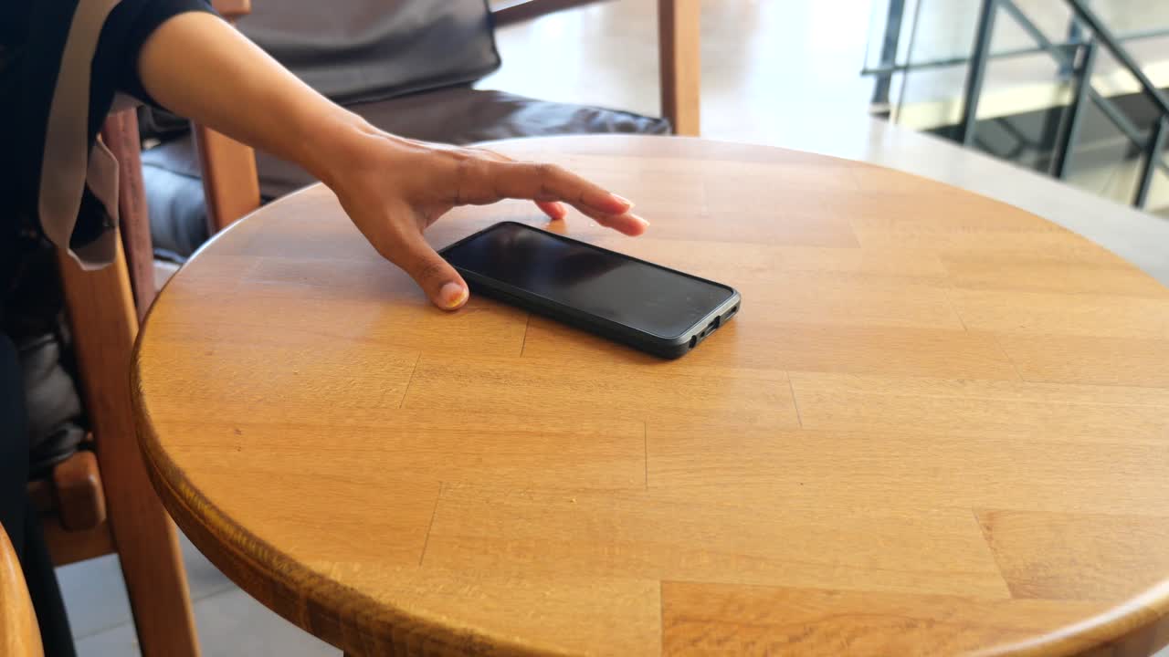 A phone on a wooden table