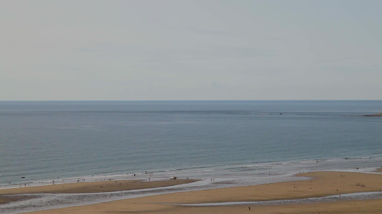 여름에 아름다운 푸른 바다와 하늘에서 수영하는 사람들의 울라컴 베이 해변 패닝 샷