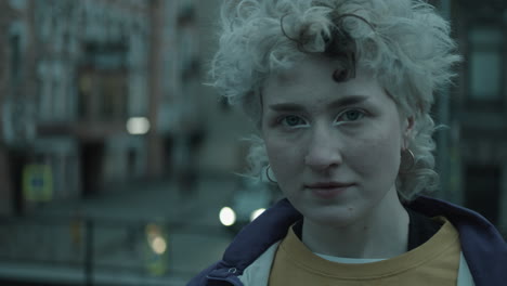 portrait of young pretty girl outdoors on city street