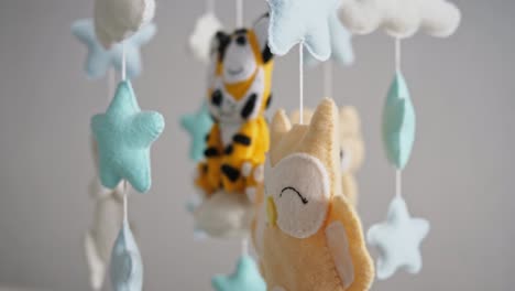 little tiger toy and colorful stars with clouds above bed