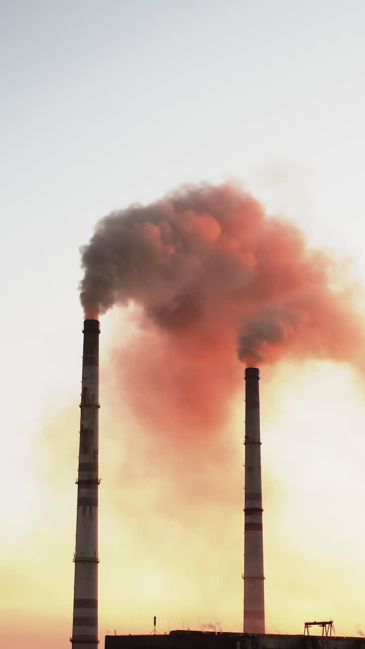 Drone view of pipes factory smoke. Aerial view of industrial zone with factory emission from factory pipes